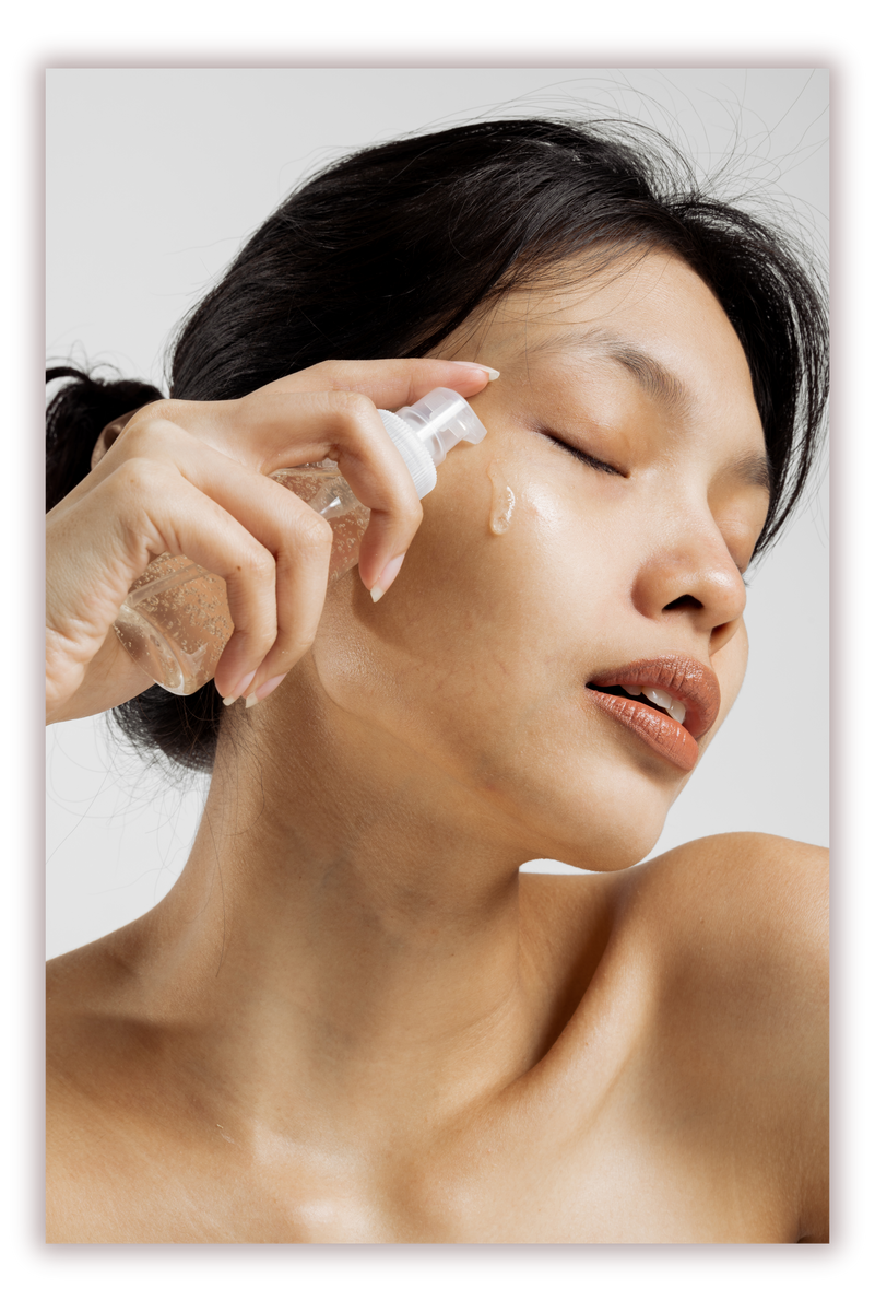 Woman Applying Cosmetic on Face from Spray Bottle